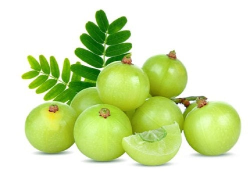 Fresh green amla fruits with leaves
