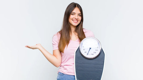 Woman holding a weighing scale
